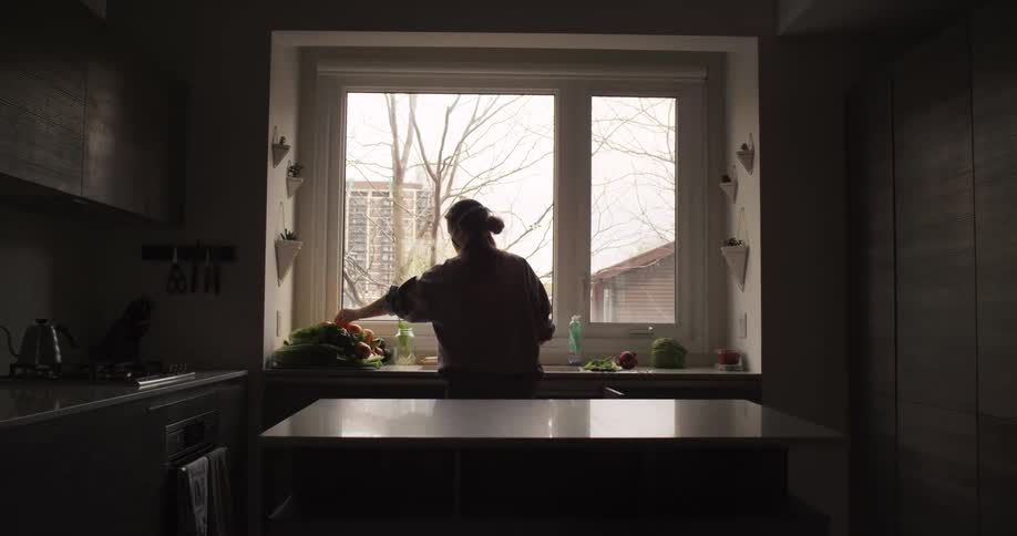 A woman is in the kitchen