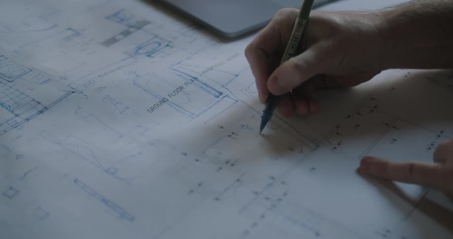 A person is writing on a diagram