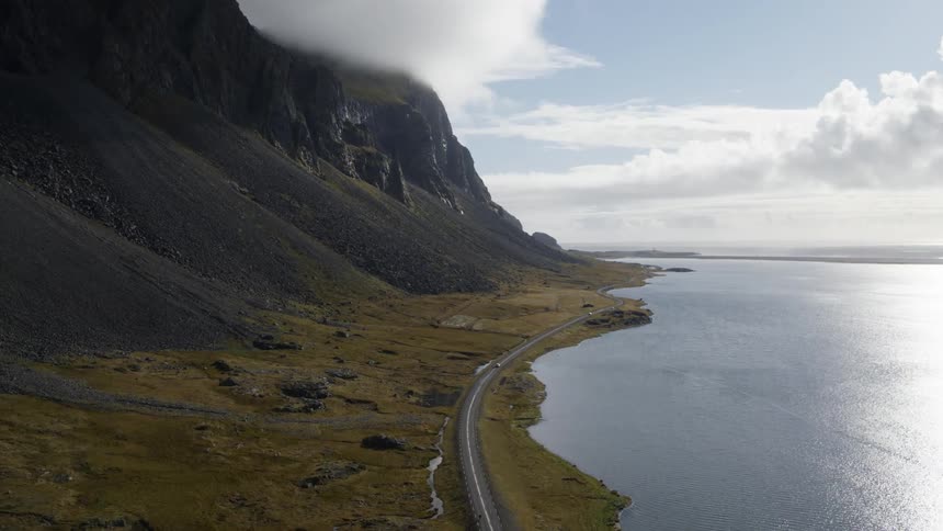 Aerial view of cars driving down a road on the shore