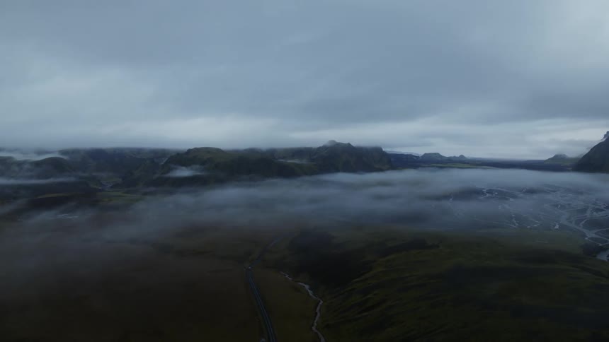 The mountain range is covered with fog