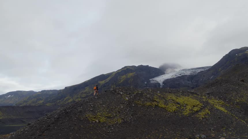 A person is hiking up the mountain