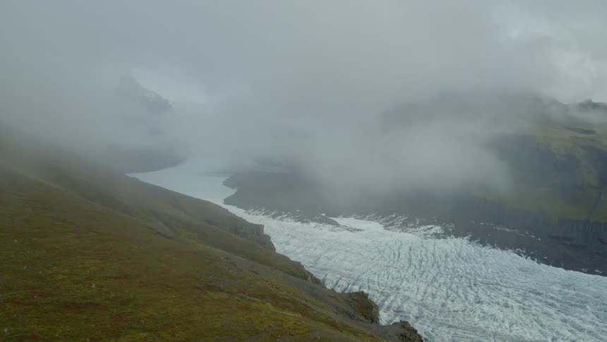 A glacier river with ice and fog