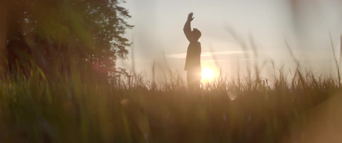 A man is practicing yoga outdoors
