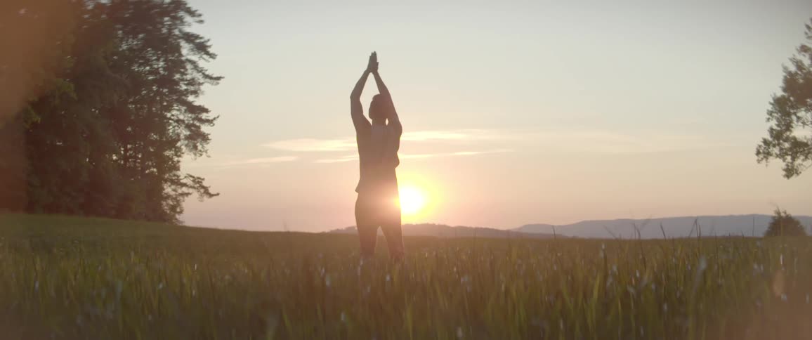 A man is doing yoga on the field