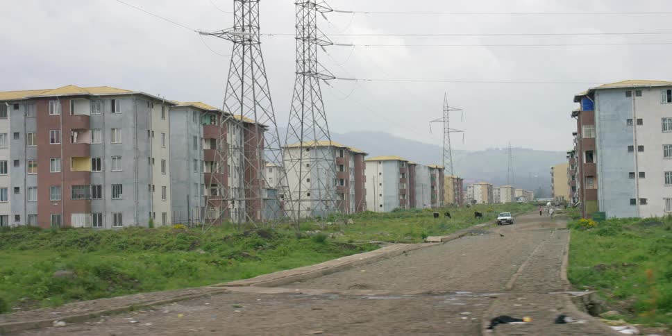 A row of apartment buildings are seen on a cloudy day