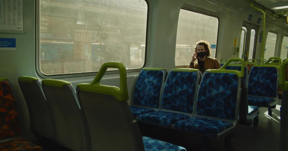 A man is riding on a city train
