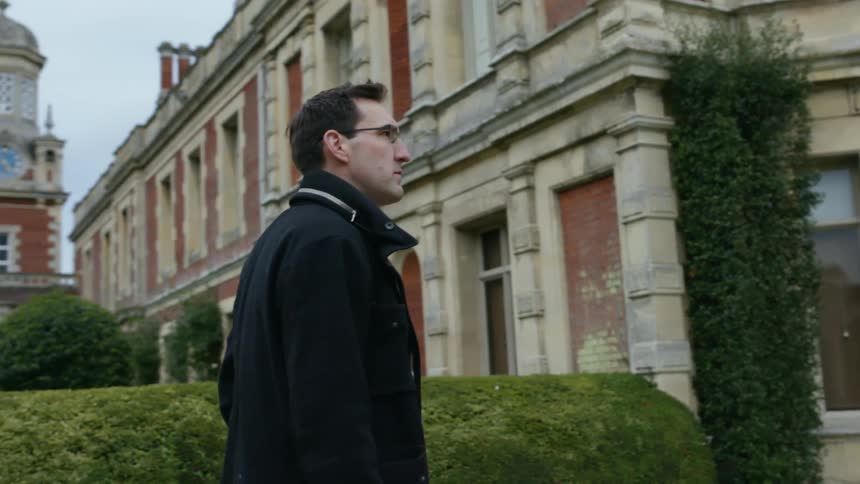 A man walks on a campus
