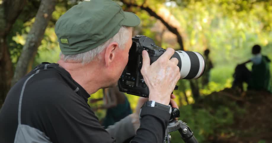 A man photographing african tribesmen