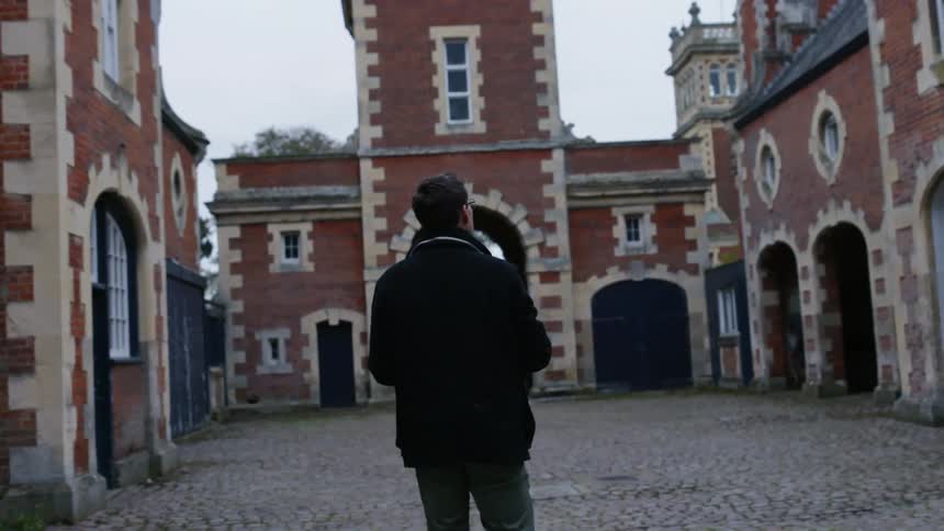 A man walks toward a building
