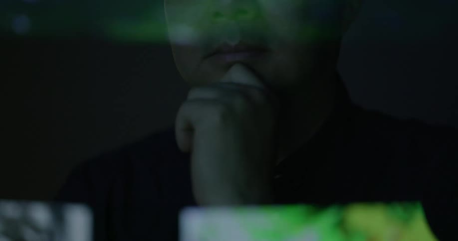 A reflection of a man face on a reflective screen