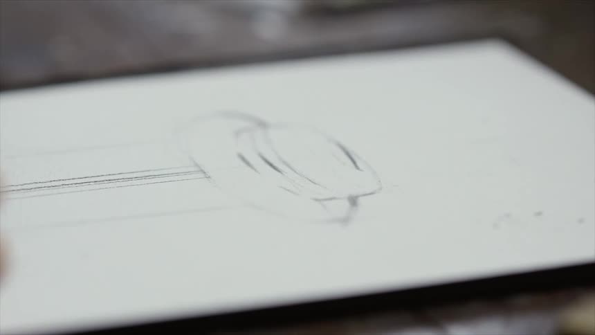 A designer drawing on paper