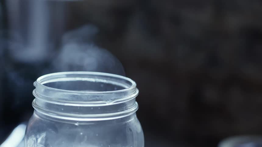 An open jar with smoke coming out of it