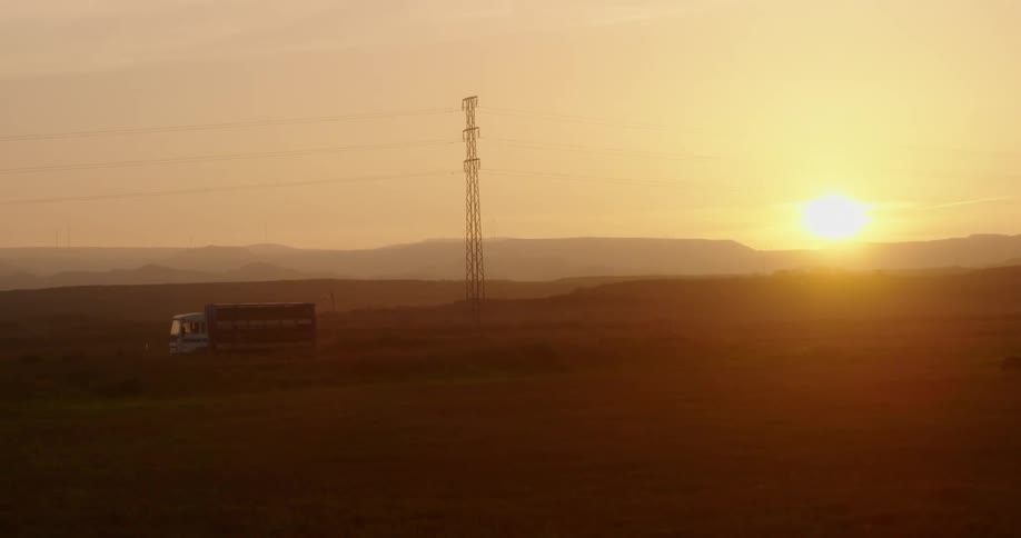 Sunset over desert and power lines