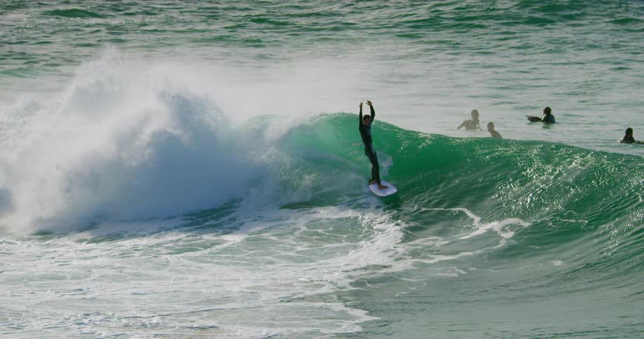 A group of surfers ride waves in the ocean