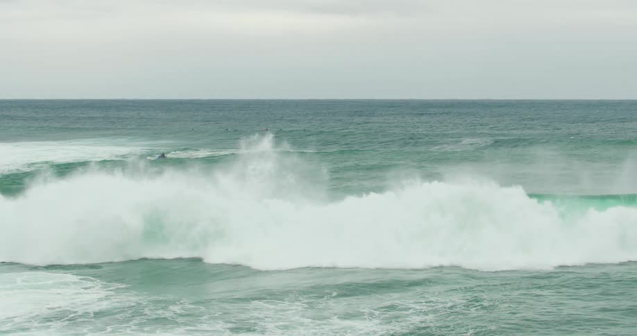 The large waves crashes on the shore