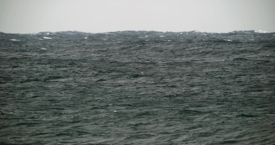 Gentle ocean waves under pale sky