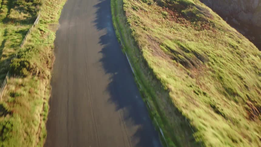 Aerial view of a road near a cliff by the ocean
