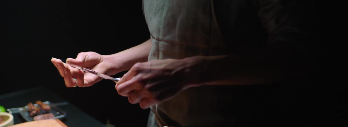 Man studies knife in kitchen