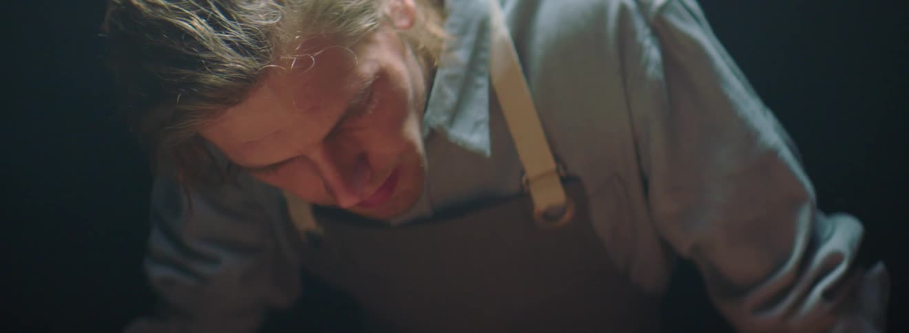A man is leaning forward working on something