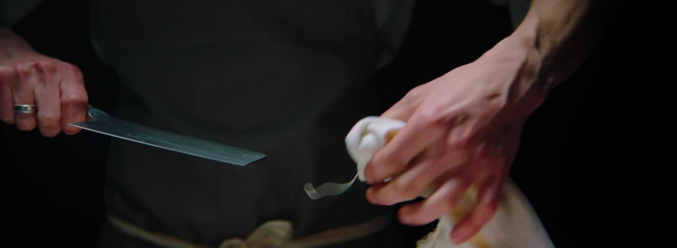 Man wipes off meat cleaver