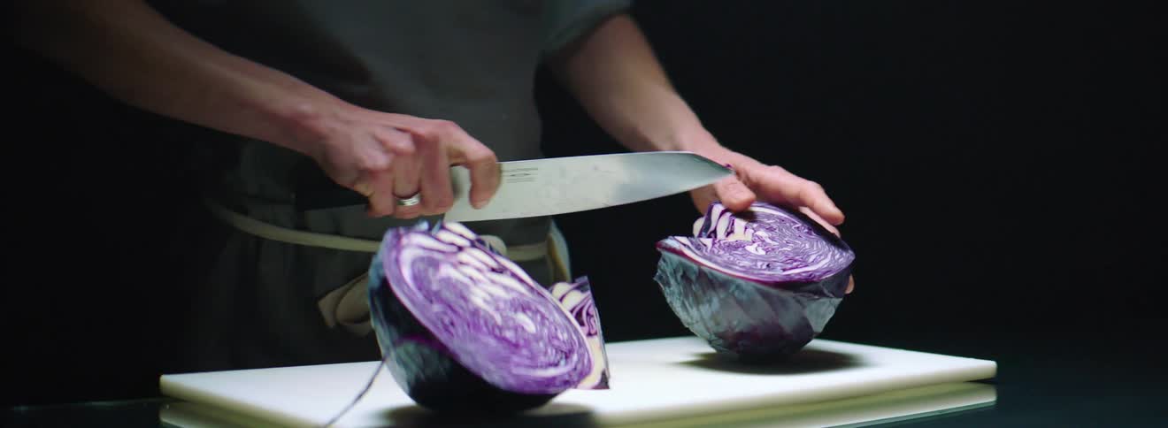 A man cuts up a cabbage