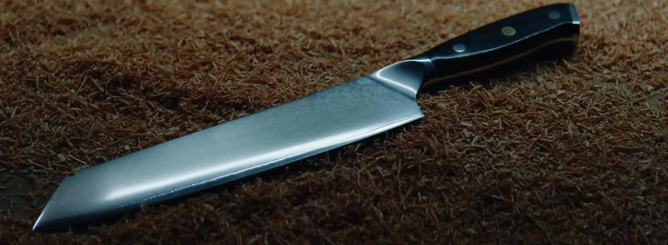 Light flashes over a long knife