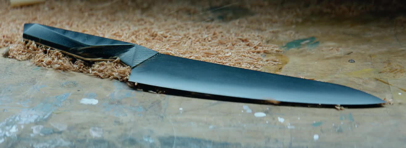Saw dust being blown away from a sharp chefs knife