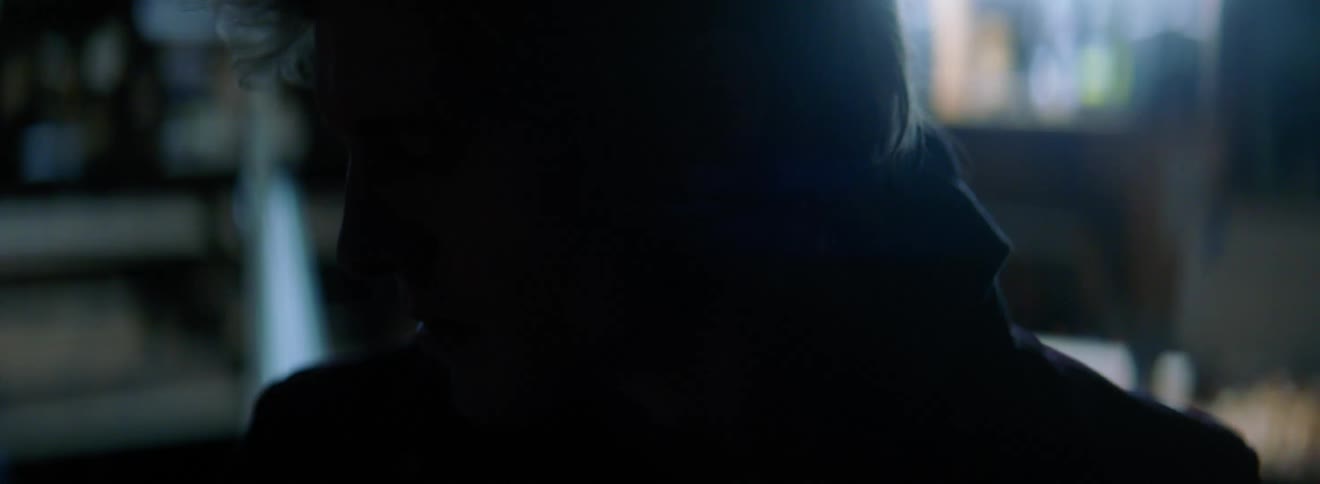 A caucasian male standing in a building that has a flashing strobe light
