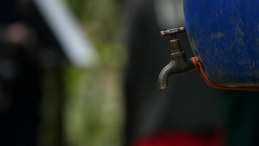 Water drips from a blue barrel