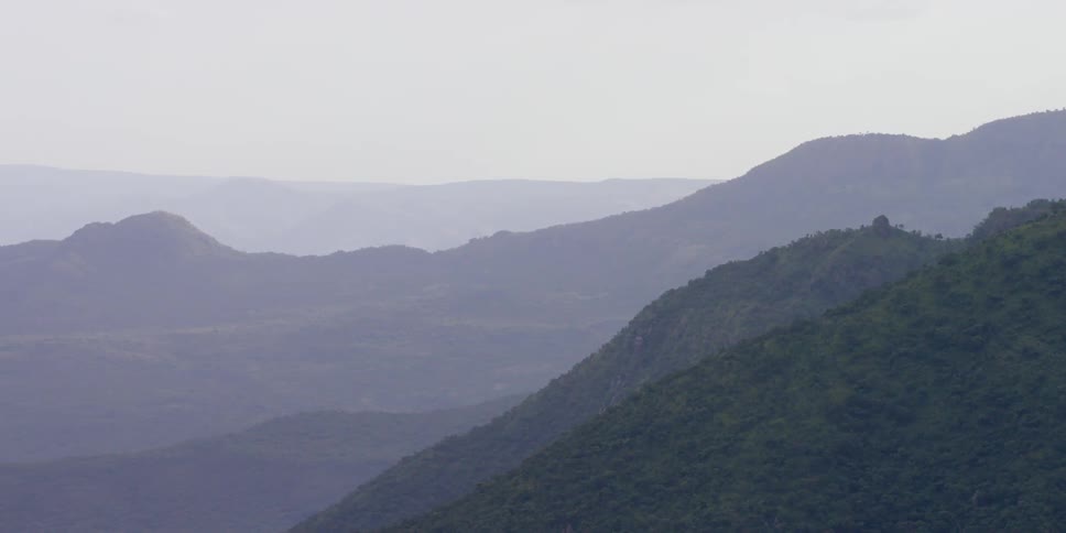 Aerial view of a mountain range shrouded in fog