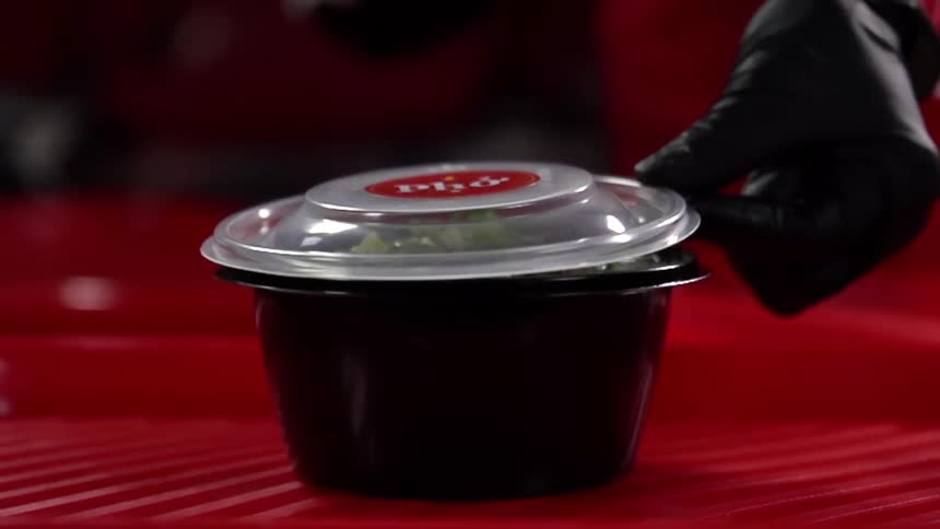 A person closes the lid on a bowl