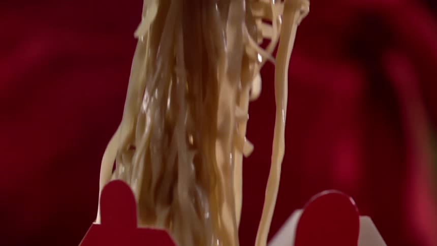 Noodles being put in to a take out box