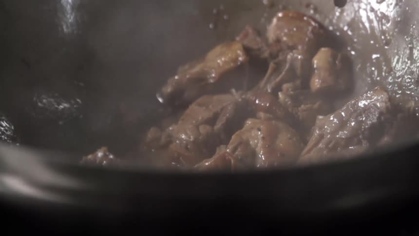 Meat cooking in a wok