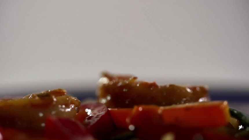 Juicy shrimps being dropped on vegetables