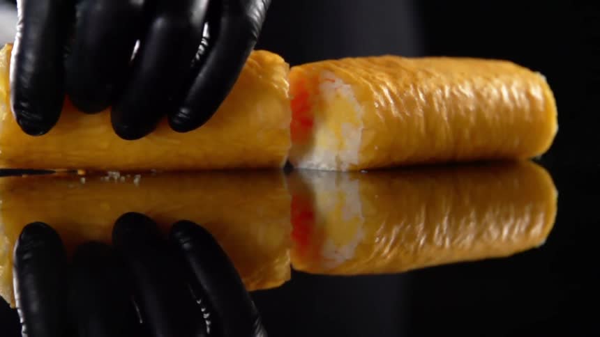 A person cuts some food in half