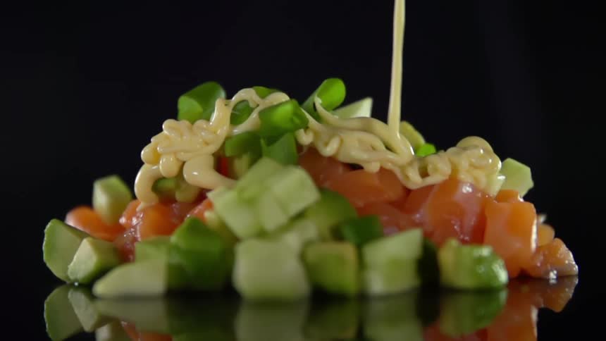 Sauce being poured on top of food