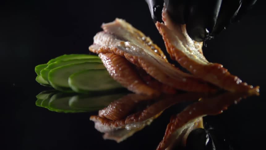 A person puts fish down on a counter