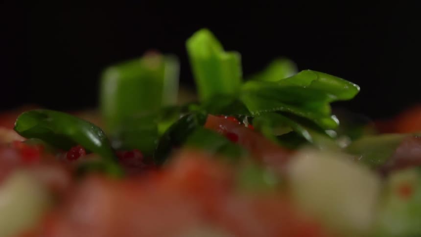 Vegetables being added to a dish