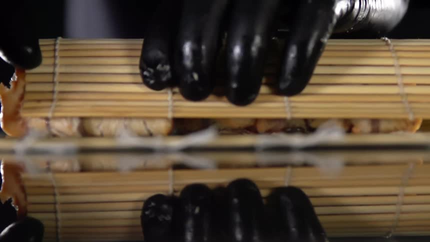 A person rolling sushi
