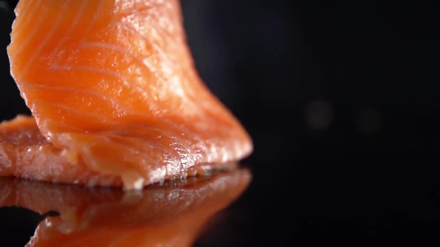A person unfolds a piece of salmon