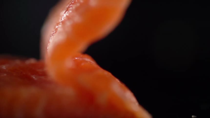 A piece of fish is rolling on the table