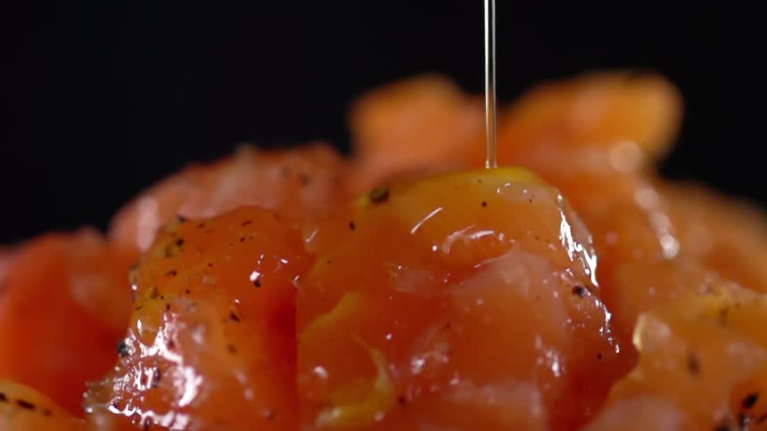 Oil being poured onto salmon