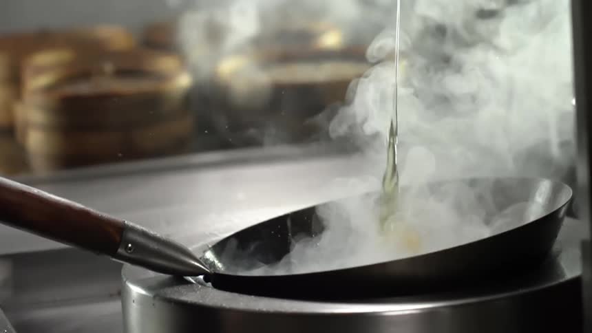 An egg falling into a smoking frying pan