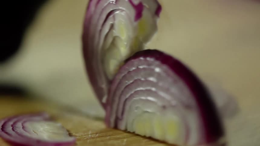 A red onion being sliced