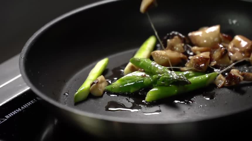 Mushrooms are dropped into the pan to fry