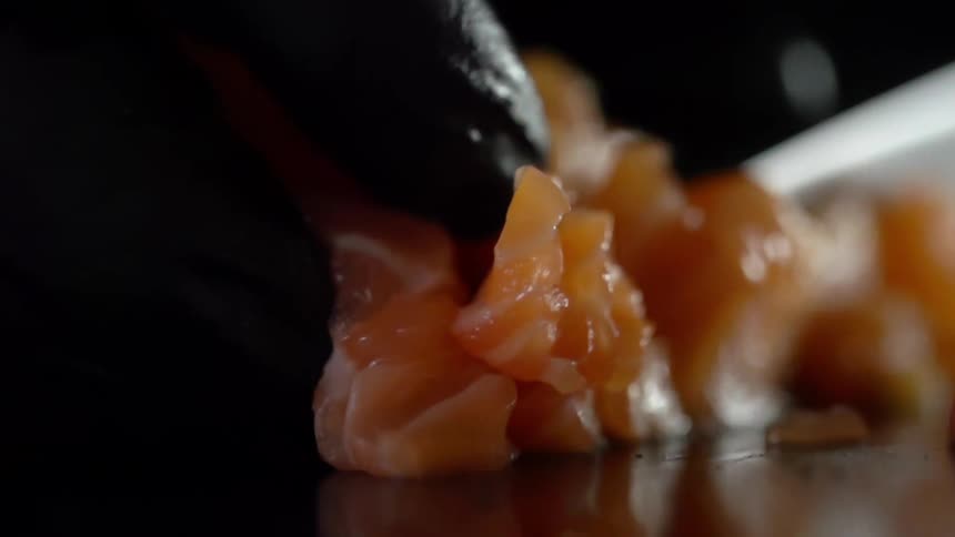 A person cutting seafood