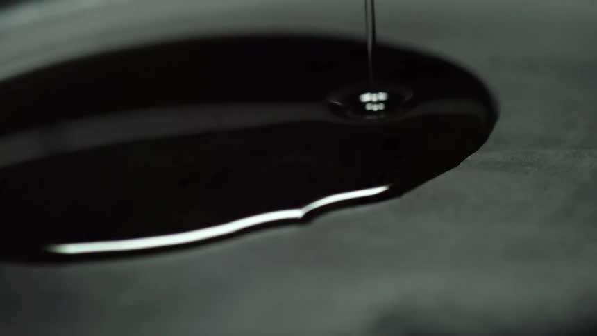 Oil spreads onto a pan as it is poured