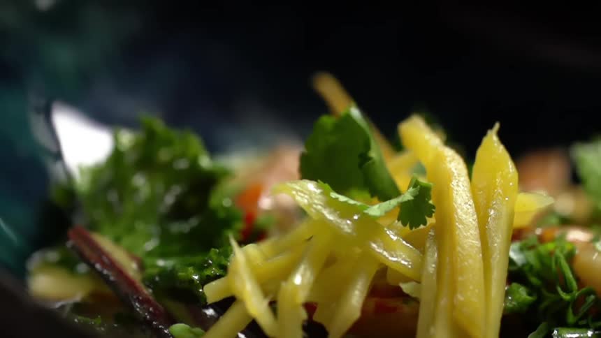 Parsley is sprinkled onto plated shrimp curry