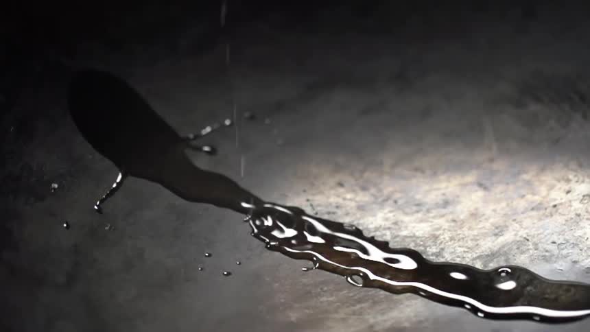 Oil being poured onto a wok