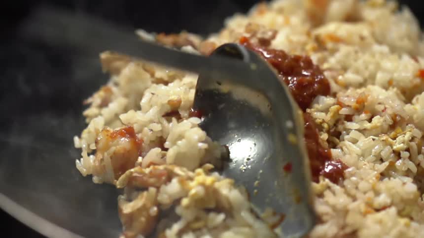 Rice with sauce being stirred